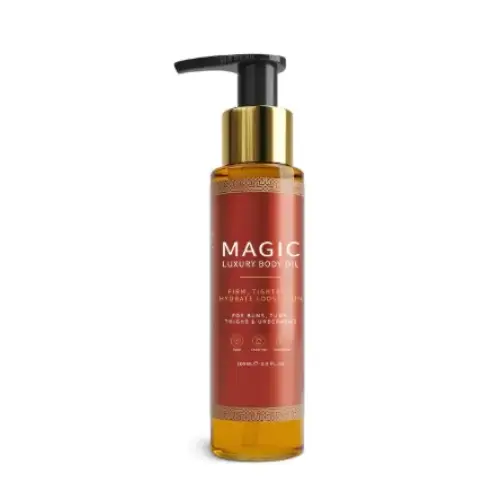 A sleek amber glass bottle of magic luxury body oil with a gold-tone pump dispenser and an elegant red label featuring intricate golden patterns.