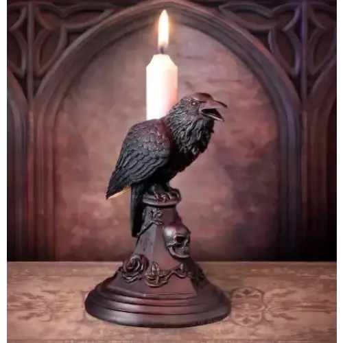 Dark, intricately detailed crow candle holder with a lit white candle perched atop its beak.