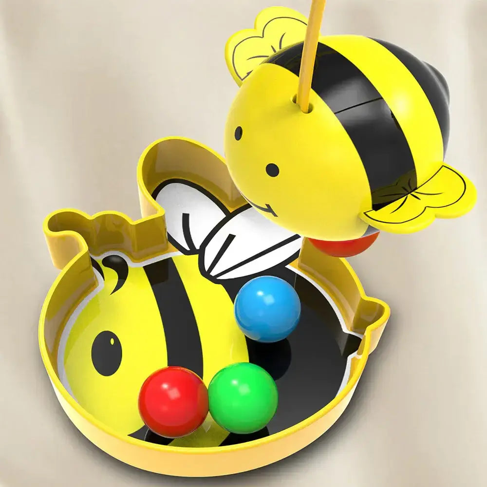 Yellow and black plastic bee-shaped toy with a smiling face, white wings, and three colorful balls inside.