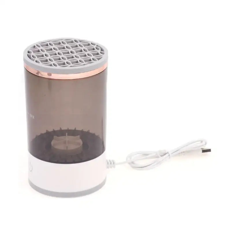 A sleek, cylindrical usb-powered humidifier with a translucent brown body, white base and top rim accent, rose gold trim around the meshed lid.