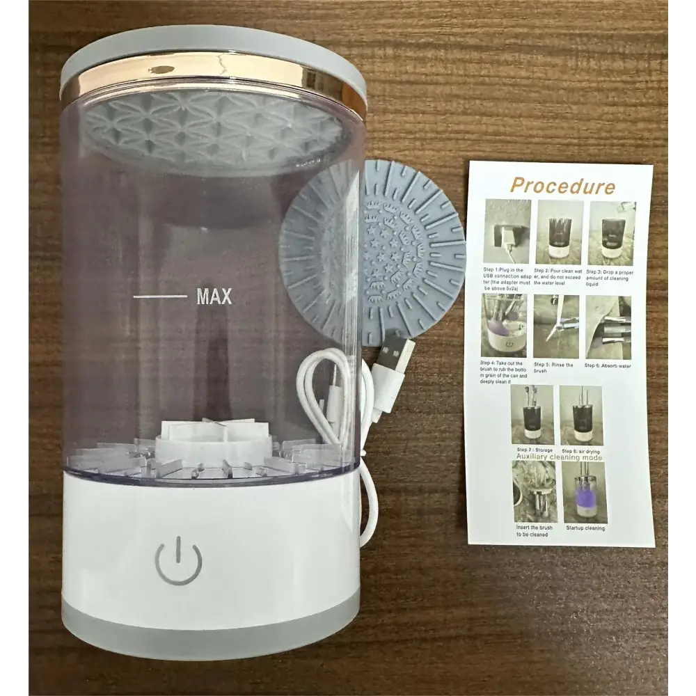 Transparent cylindrical oral irrigator with a white base and gold-accented lid, featuring an integrated usb charging cable.