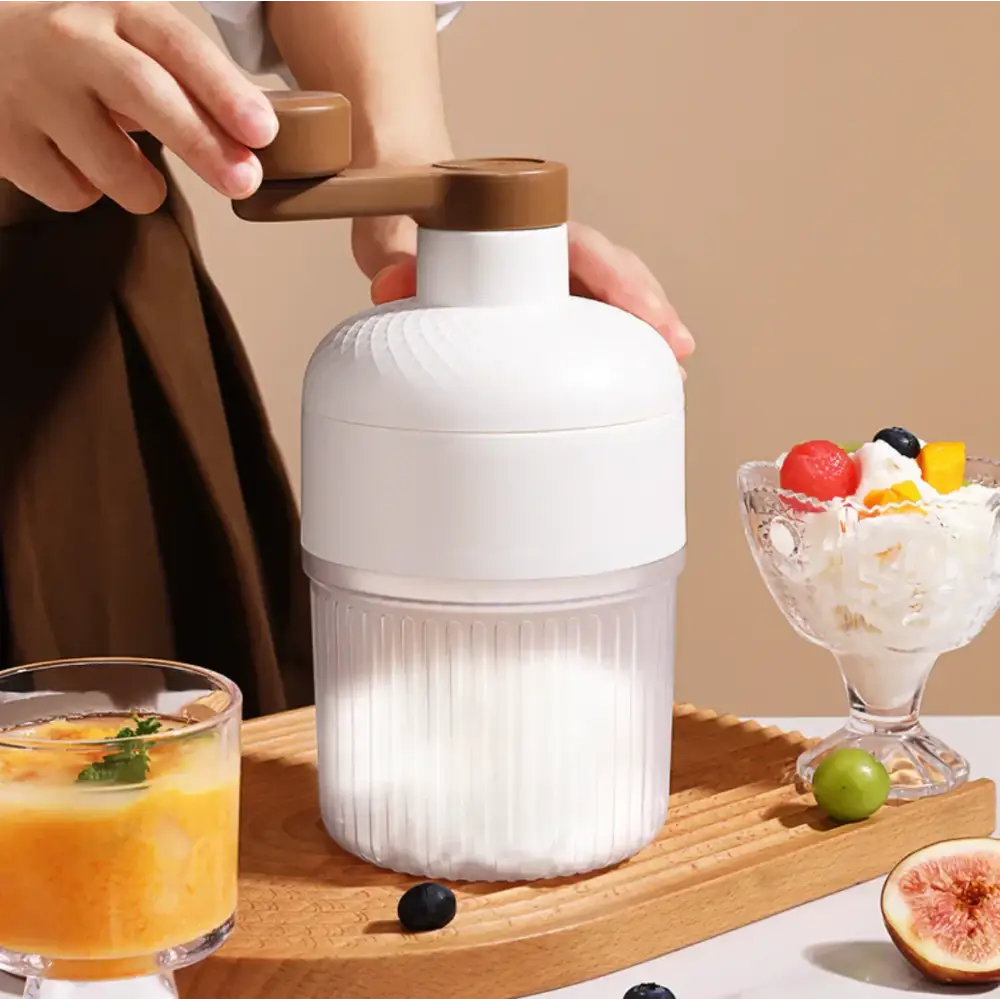 White and brown handheld manual fruit grinder with ribbed plastic body.