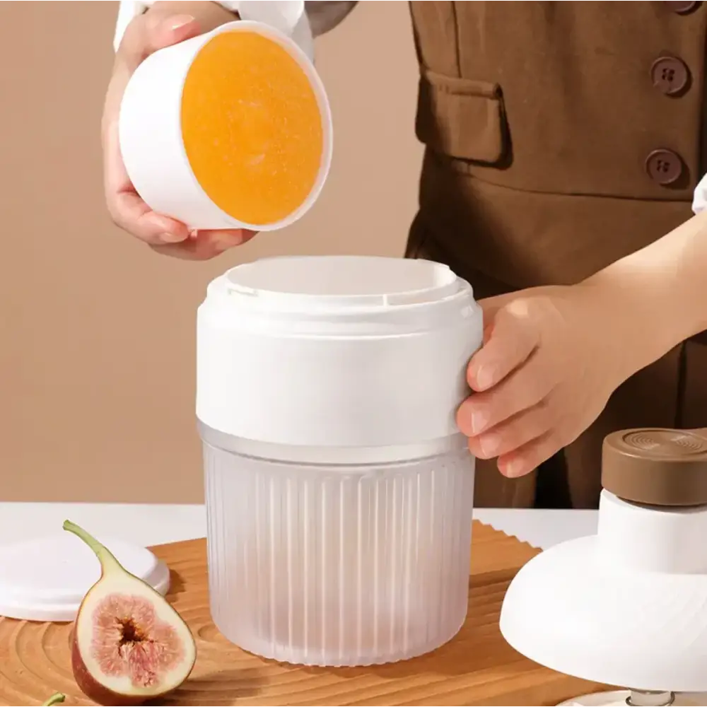 White plastic handheld blender with ribbed translucent container and lid