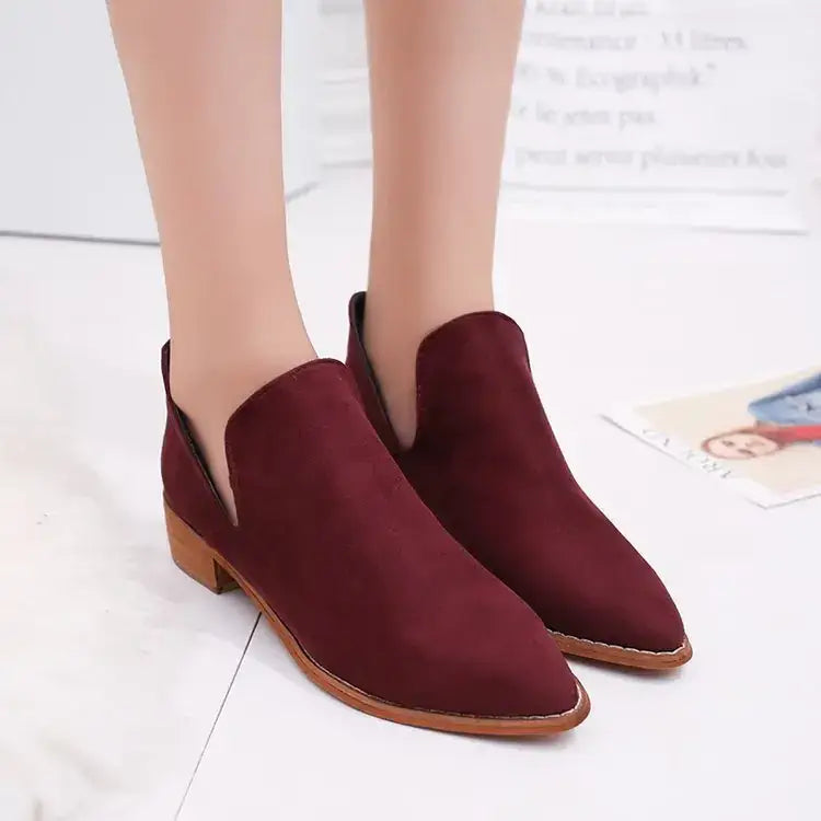 Burgundy suede ankle boots with a low block heel and tan leather sole.