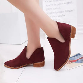 Maroon suede ankle boot with a low block heel and tan leather sole.