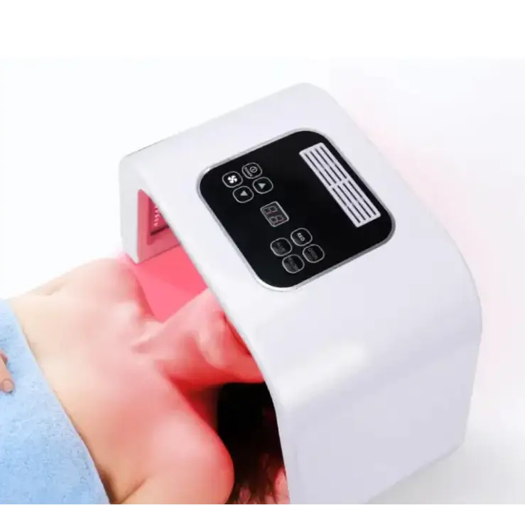 White rectangular led facial mask with black control panel and red light emitting from the interior.