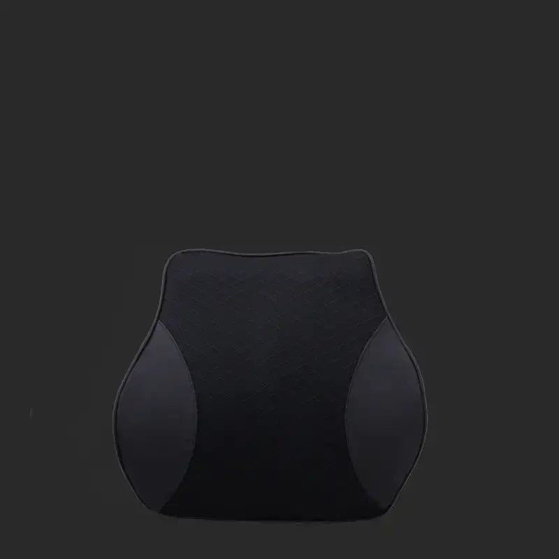 Black ergonomic lumbar support cushion with contoured shape and soft fabric surface.