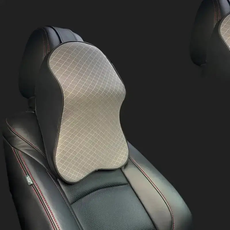 Gray mesh-patterned car neck pillow with black leather trim.