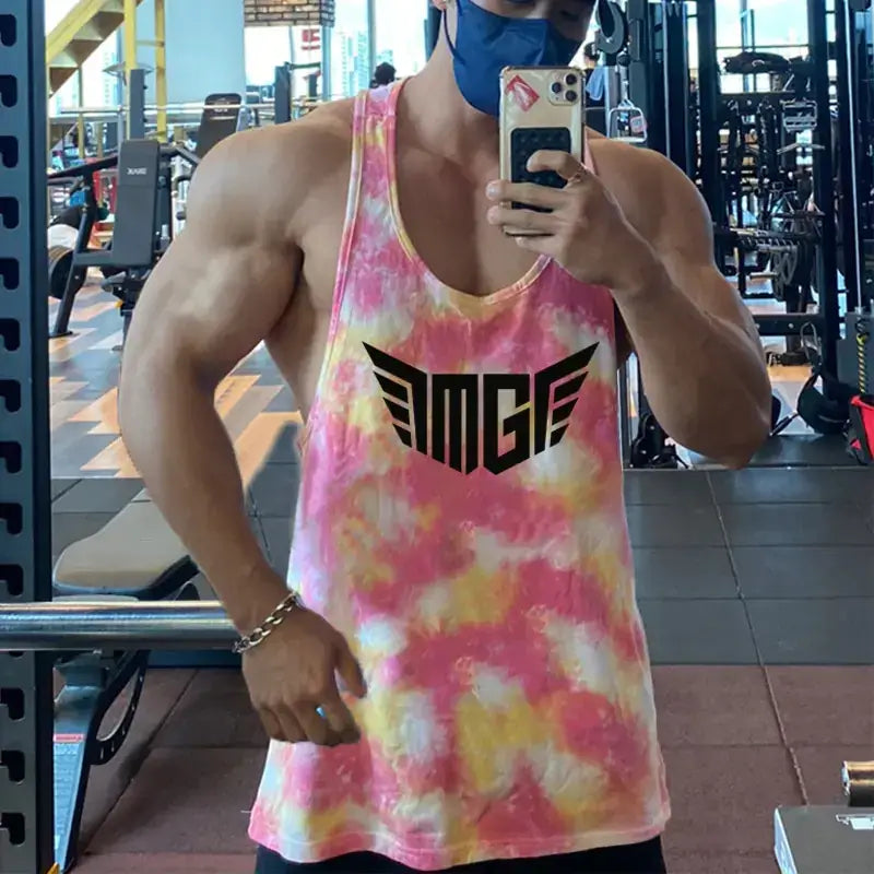 Pink and yellow tie-dye muscle tank top with black ’mge’ logo