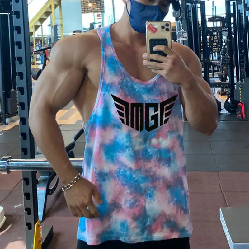 A vibrant blue, pink, and white tie-dye tank top featuring a bold black ’amge’ logo across the chest.