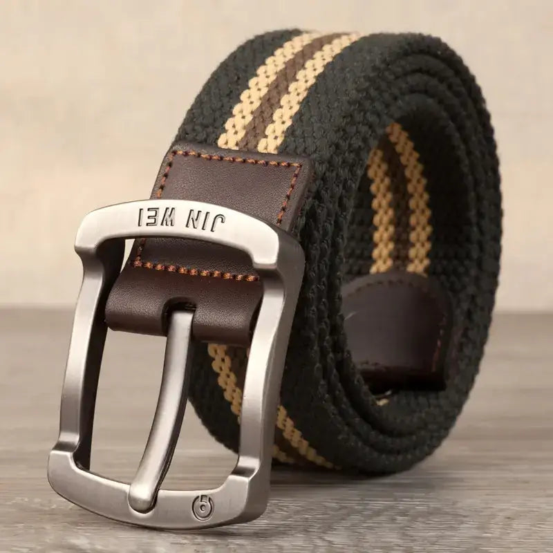 Black and tan woven canvas belt with a silver-toned buckle featuring the brand name ’jin wei’ engraved on it.