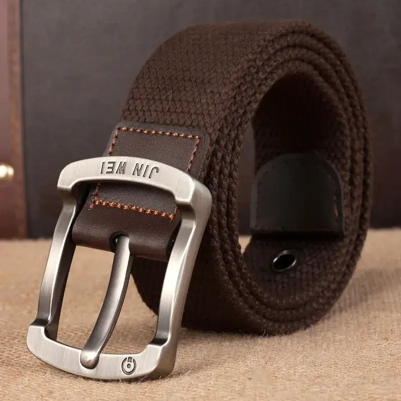 Brown woven canvas belt with a silver-toned metal buckle engraved with ’jin wei’.
