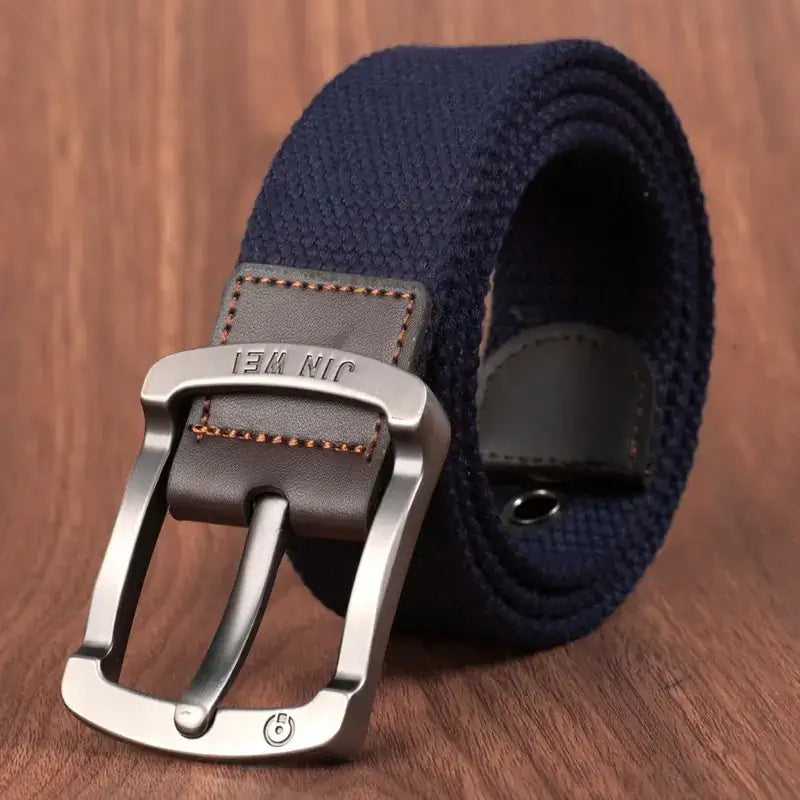Navy blue woven canvas belt with a silver-toned metal buckle and brown leather accent stitching