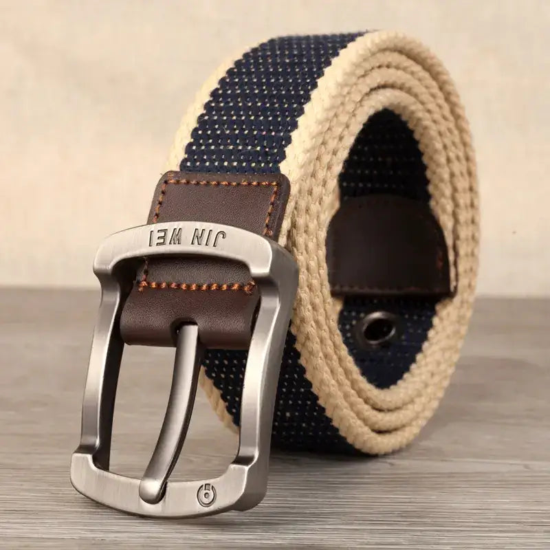 Navy blue and beige woven canvas belt with a brown leather tab and silver-toned metal buckle.