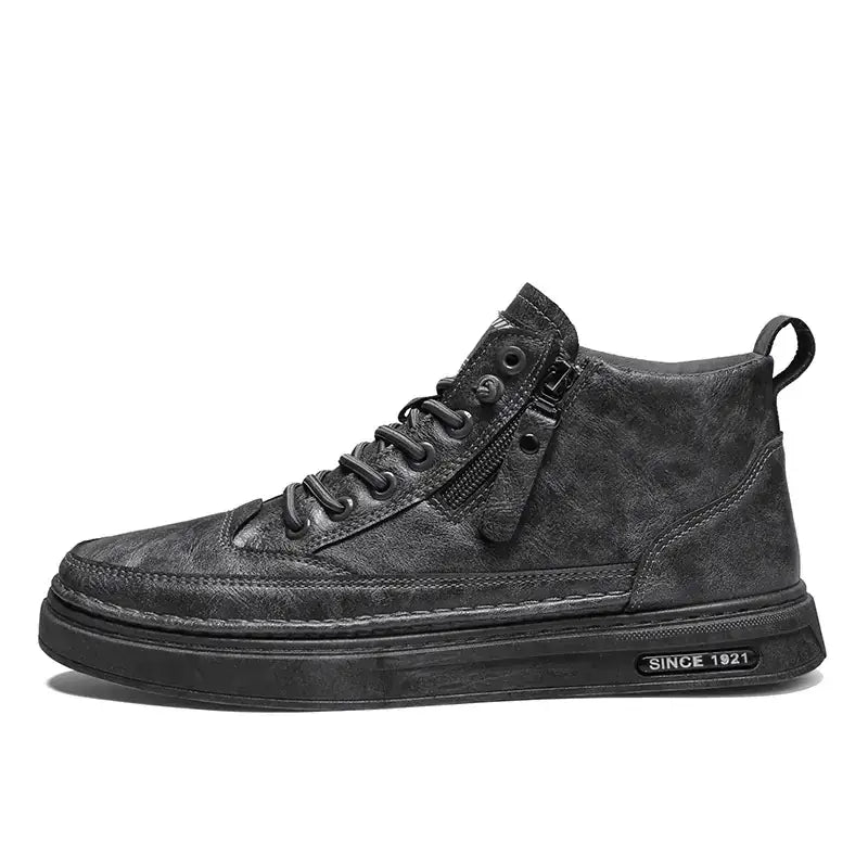 Black high-top sneaker with a textured, distressed leather upper and a chunky rubber sole featuring ’since 1921’’ branding.