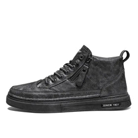 Black high-top sneaker with a textured, distressed leather upper and a chunky rubber sole featuring ’since 1921’’ branding.