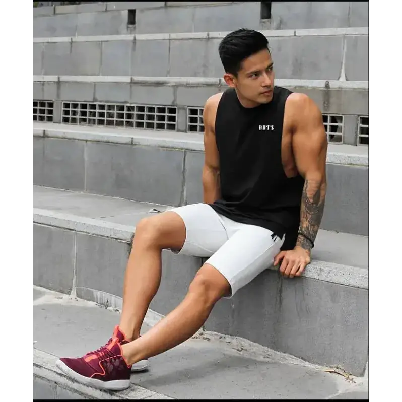 Black sleeveless athletic tank top with ’buti’ logo on the chest