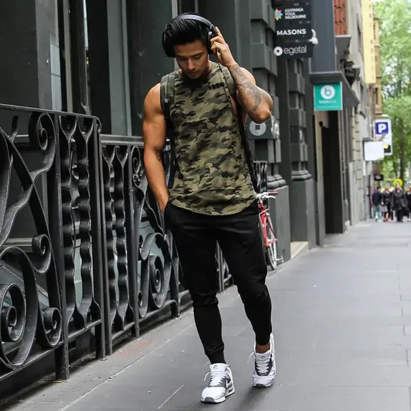 Man wearing camouflage sleeveless top and black pants