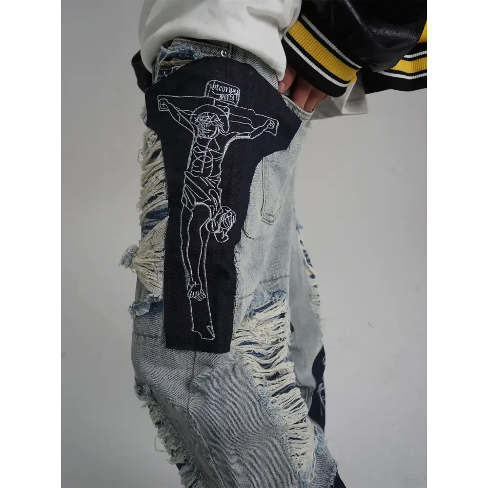 Black embroidered patch featuring a white outline of jesus on the cross, with ’broken bottle’ stitched above.