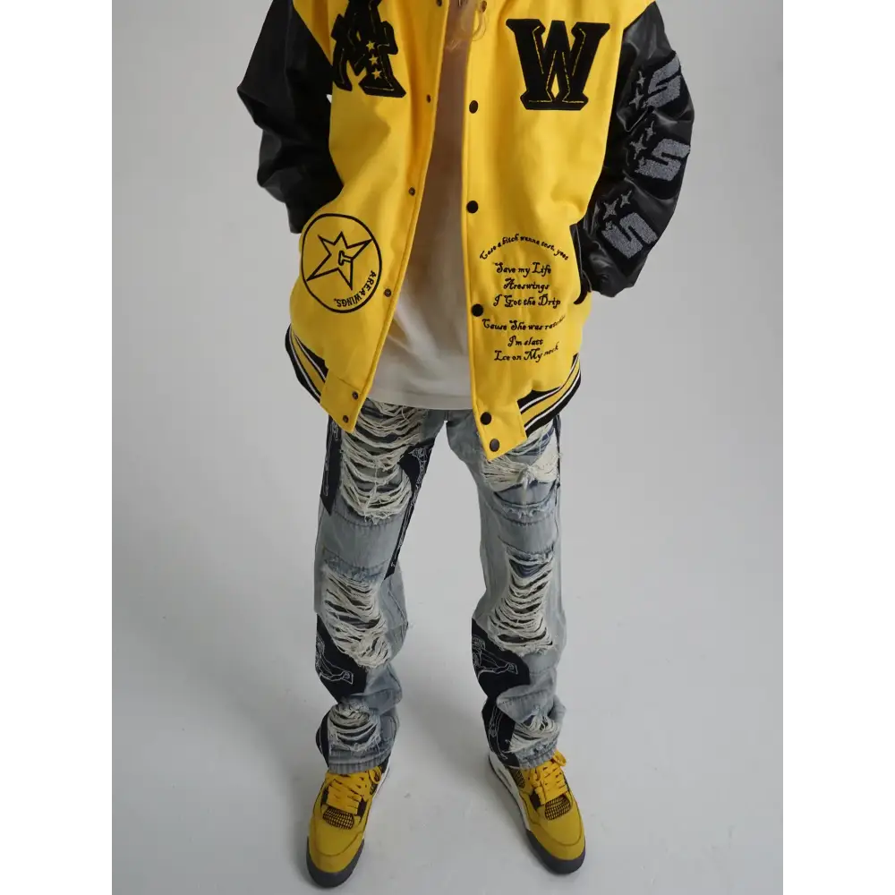 Yellow and black varsity jacket with embroidered lettering, star patches, and distressed sleeves.