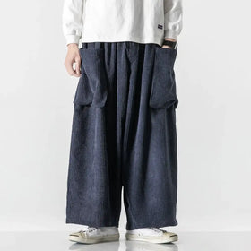 Dark blue corduroy wide-leg pants with prominent vertical ribs and large front pockets.