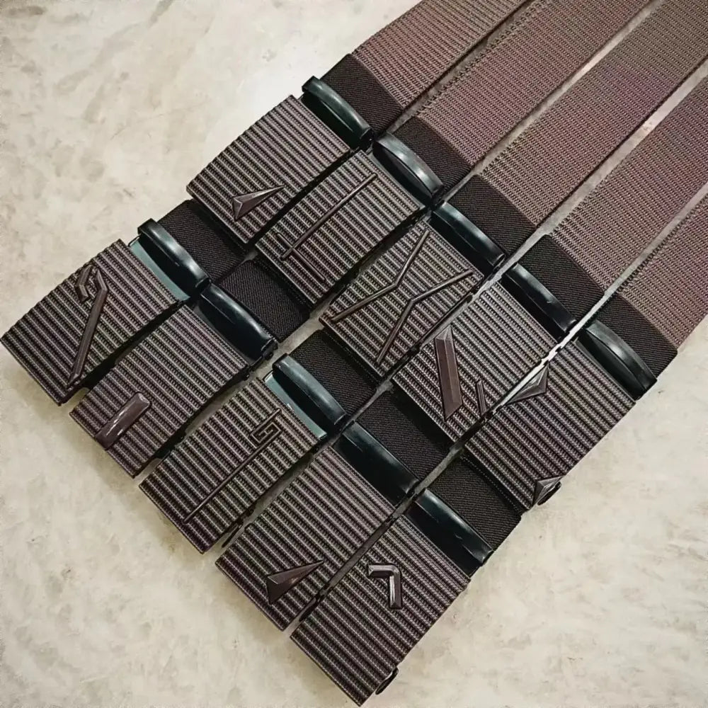 Brown woven belt with a textured, ribbed buckle featuring embossed geometric patterns and black plastic accents.