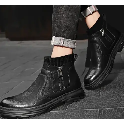 Black leather ankle boots with a glossy finish and visible stitching details.
