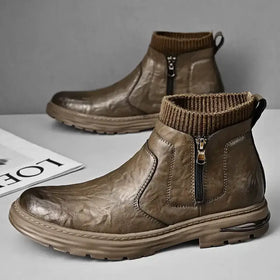 Brown leather ankle boots with a ribbed knit cuff and side zipper.