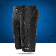 Black yuke swim trunks with a sleek, form-fitting design and subtle white branding at the bottom.