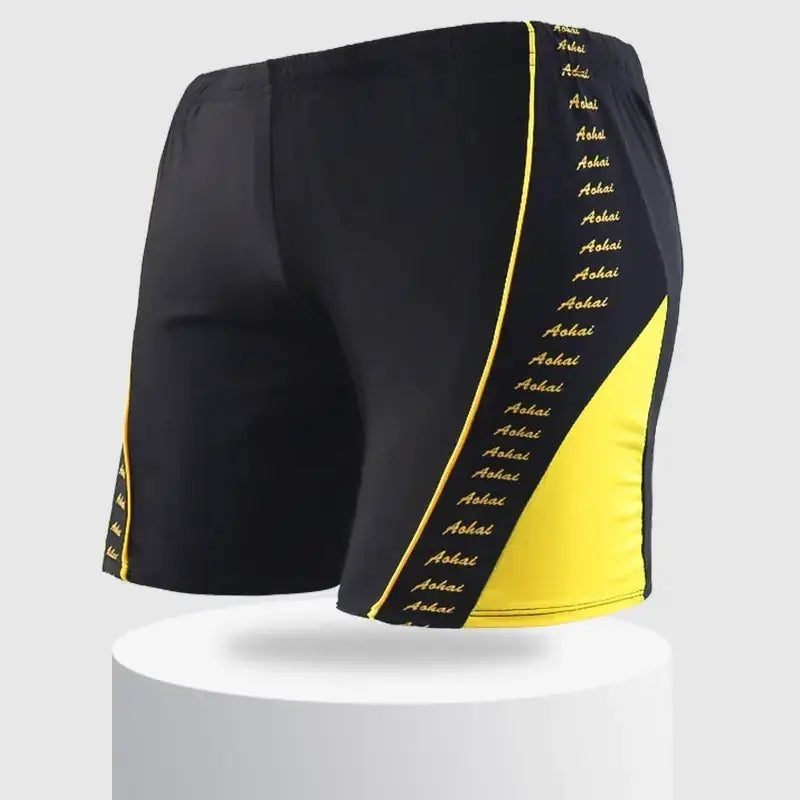 Black and yellow swim trunks with a bold diagonal stripe featuring the word ’aohai’ repeated in gold lettering along the side.
