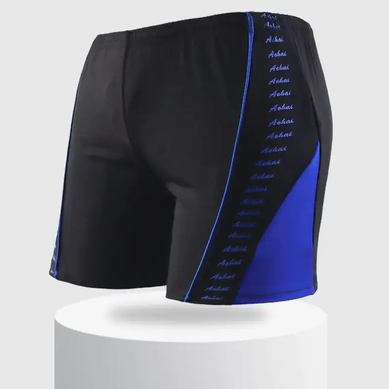 Black swim trunks with bold blue side panels and a vertical stripe of the word ’aohai’ in light blue script.