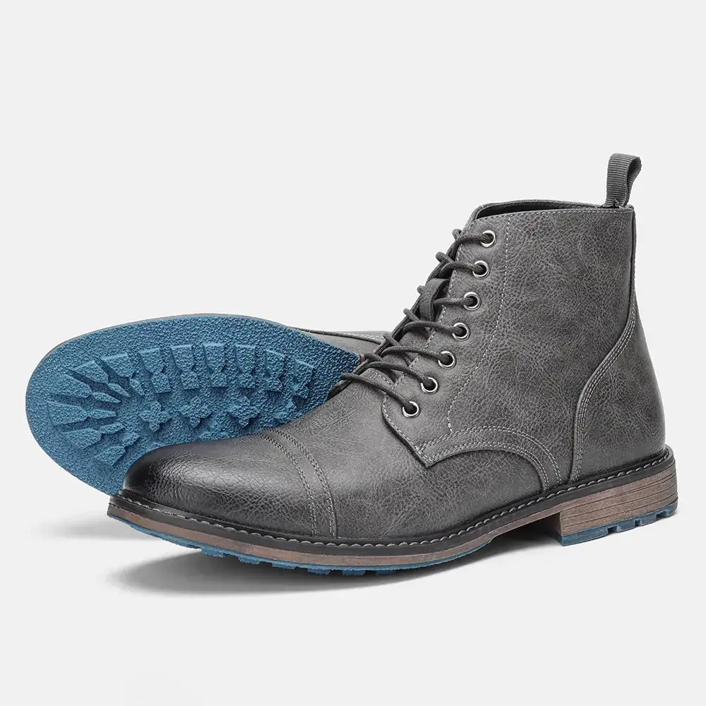 Dark gray distressed leather lace-up ankle boot with a contrasting blue rubber sole and brown midsole.