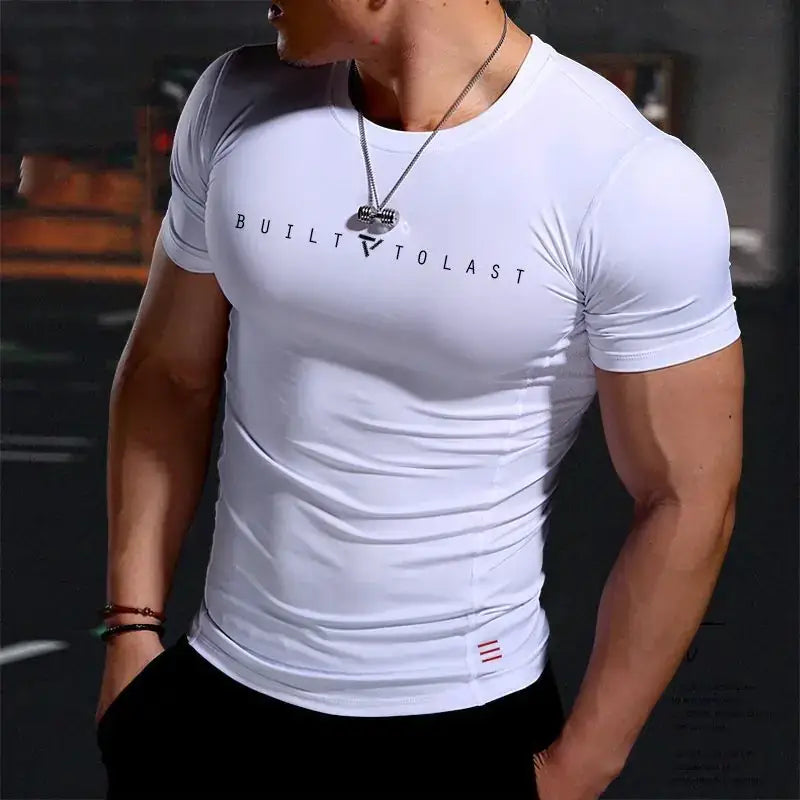 White short-sleeved compression shirt with ’built to last’ printed across the chest in black lettering.