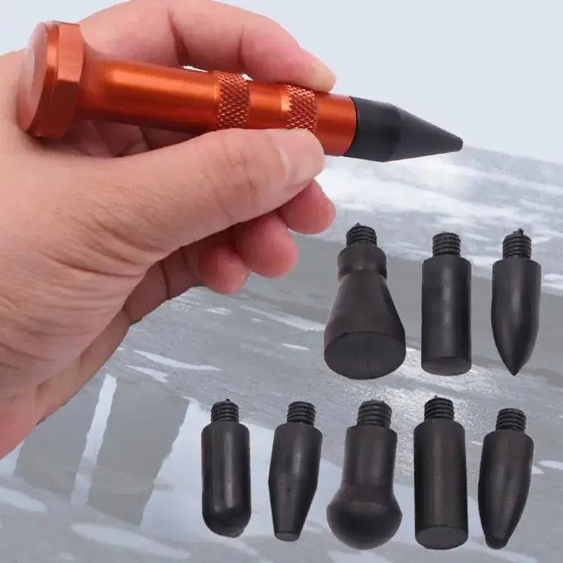 Orange and black automotive dent repair tool with interchangeable rubber tips
