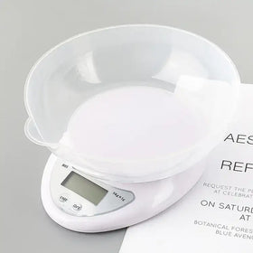 White digital kitchen scale with transparent bowl on top
