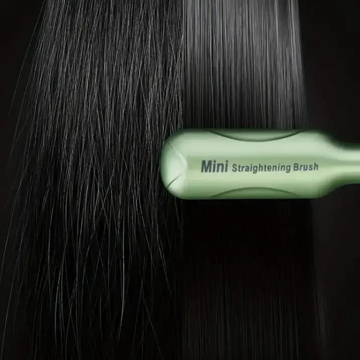 Light green mini straightening brush with a sleek, ergonomic handle and smooth bristles.