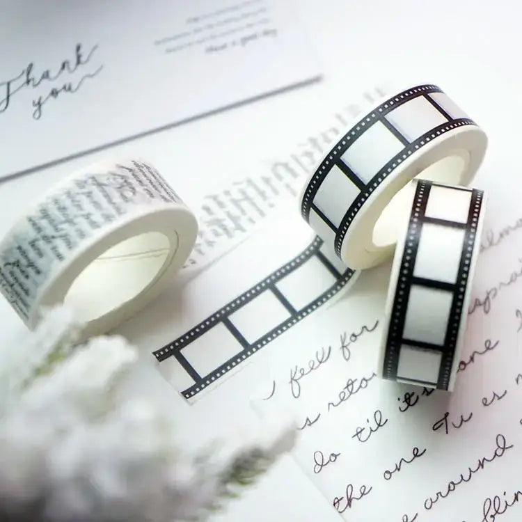 Black and white filmstrip-patterned washi tape rolls.