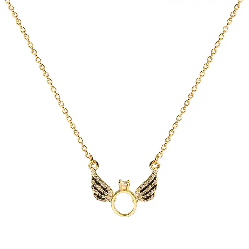 Gold-toned necklace featuring a delicate chain and an angel wing pendant with sparkling rhinestones.