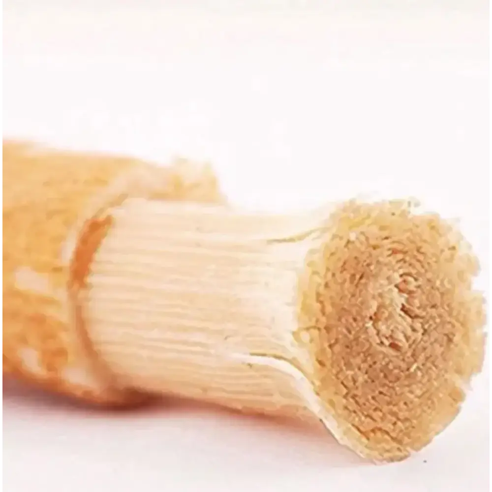 A light brown, textured wooden pencil with a visible wood grain and natural fiber tip.