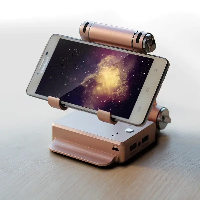 Rose gold smartphone stand with integrated charging port and usb ports, holding a phone displaying a cosmic nebula wallpaper.