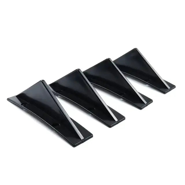 Set of four sleek black triangular car rear spoiler fins with glossy finish.