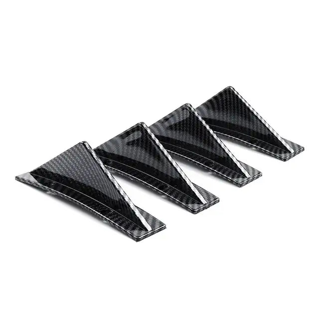 Black carbon fiber triangular car door handle trim pieces.