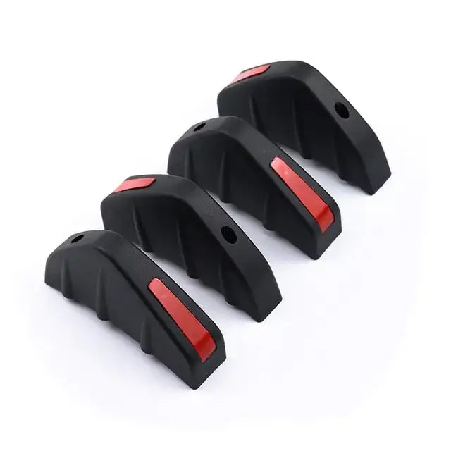 Black plastic car bumper guards with red reflective strips.