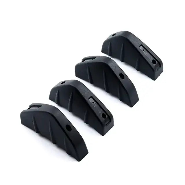 Black rubberized grip inserts for firearm stocks.