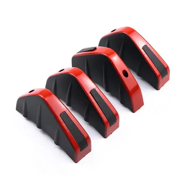 Red and black rubber car wheel chocks with textured grip surfaces.