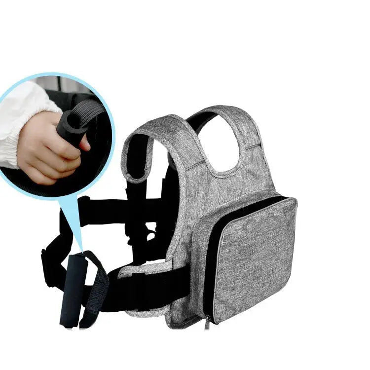 Gray textured fabric toddler walker with black adjustable straps and a front zippered pocket.