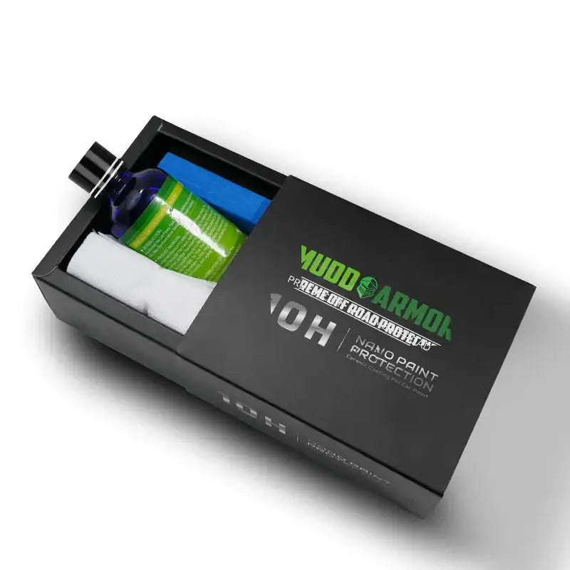 Black rectangular box containing a green bottle, blue sponge, and white cloth for mud armor 10h nano paint protection.