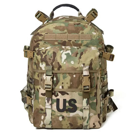 Multicam-patterned tactical backpack with tan and olive green camouflage, featuring a prominent ’us’ patch on the front.
