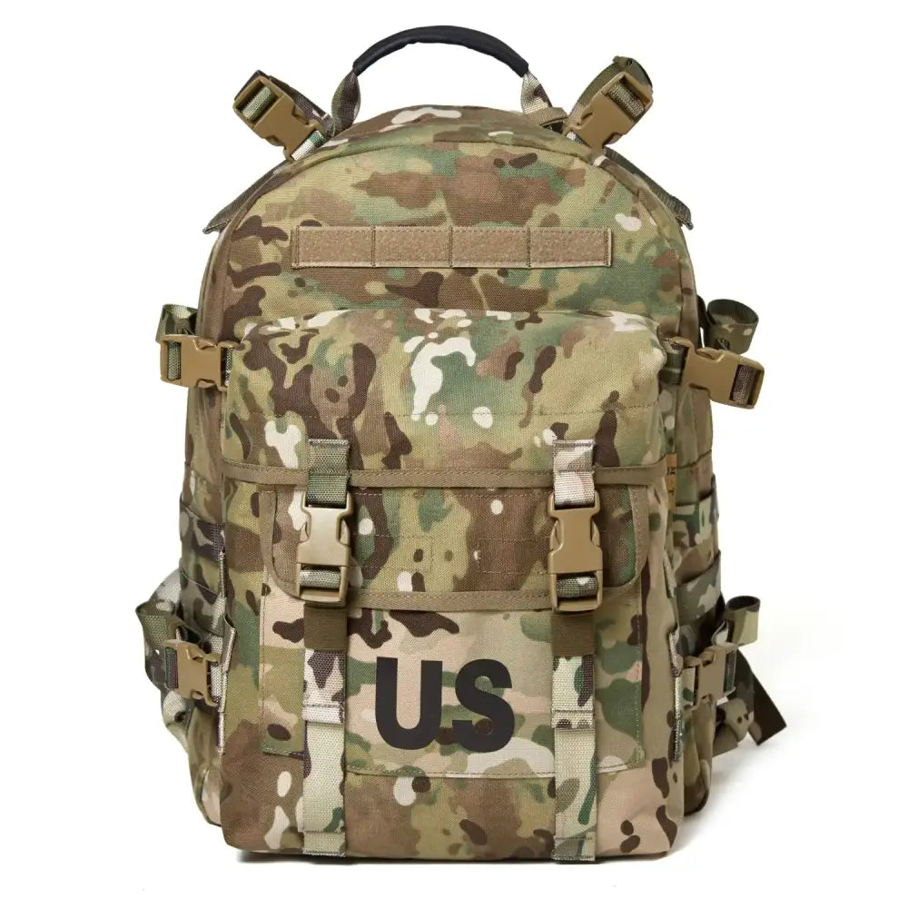 Multicam-patterned tactical backpack with tan and olive green camouflage, featuring a prominent ’us’ patch on the front.