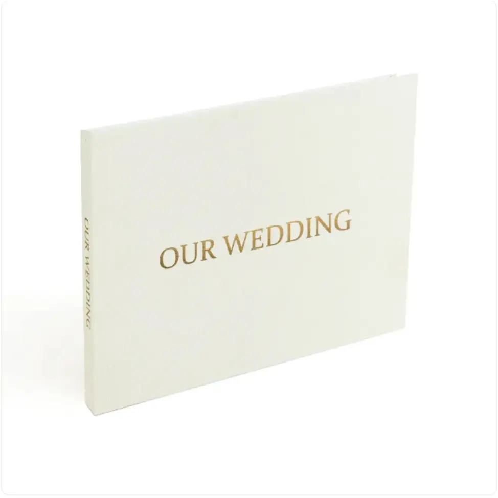 Cream-colored wedding photo album with elegant gold foil lettering.